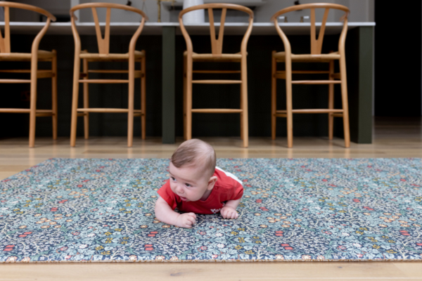 Baby doing tummy time on a luxury Totter + Tumble playmat.