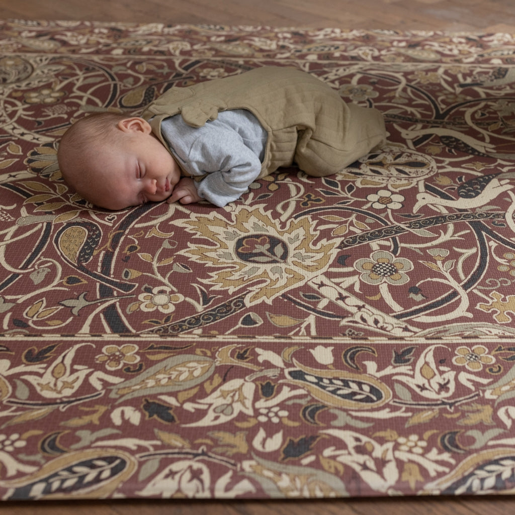 Baby lays on a memory foam, non-toxic, morris & co patterend playmat
