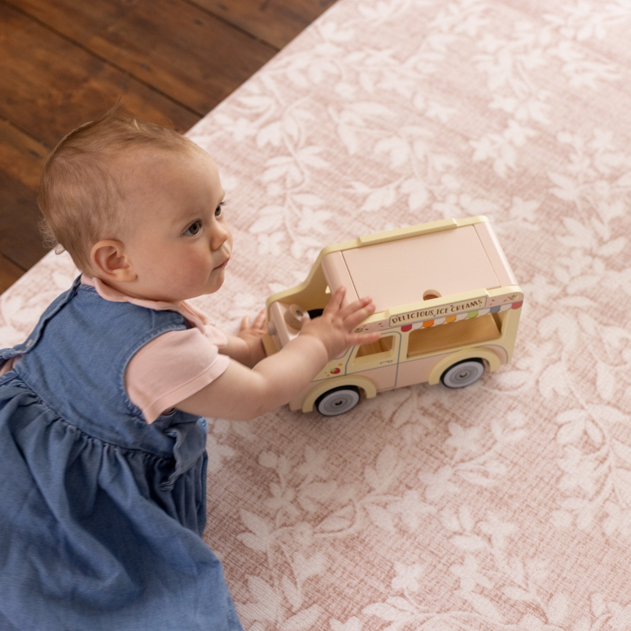 Baby on a safe non toxic floral pink playmat from Totter and Tumble