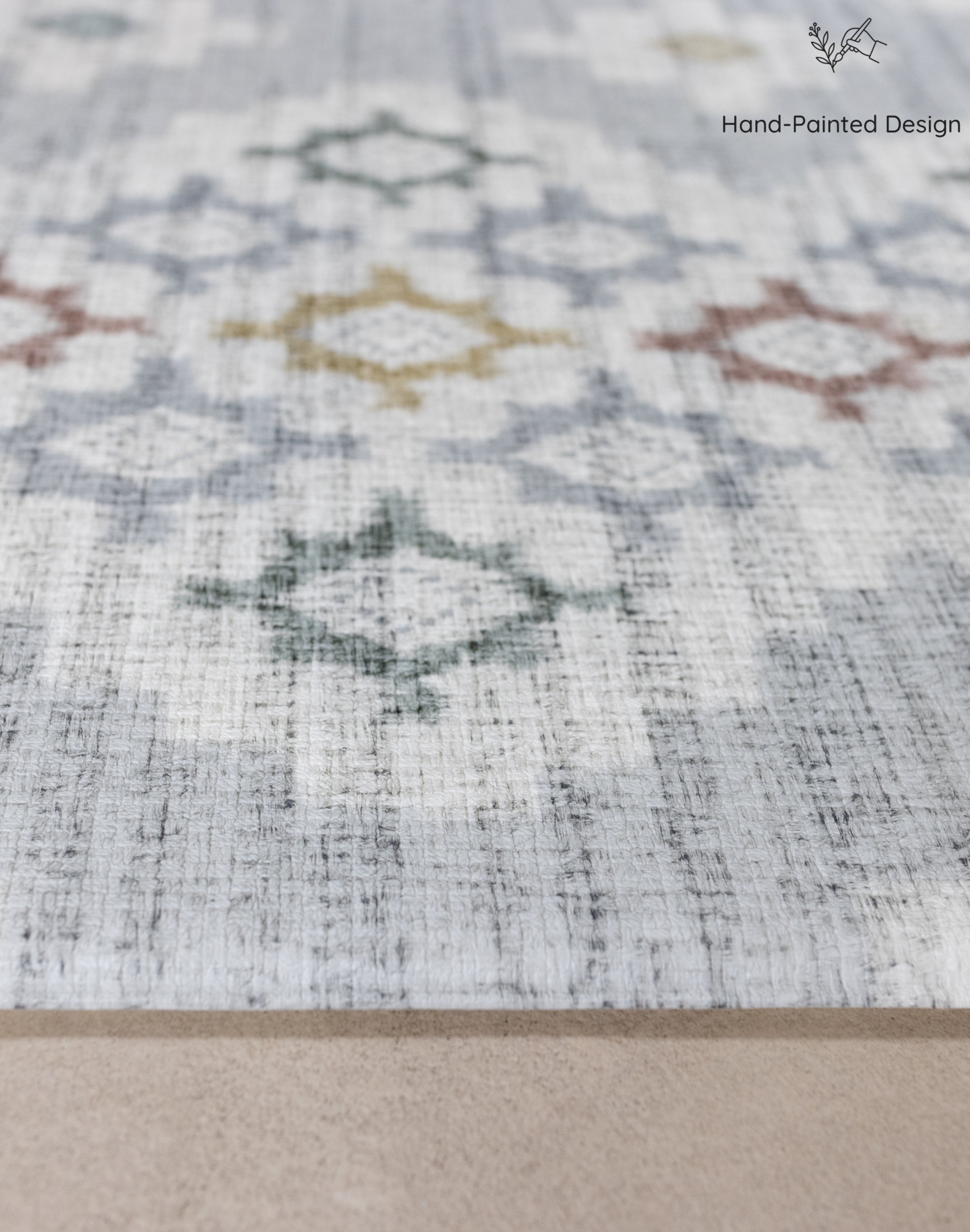 Close-up of a thick totter and tumble play mat with geometric designs on a neutral blue background
