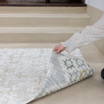 reverisble play mat being held by the corner to show both designs. 