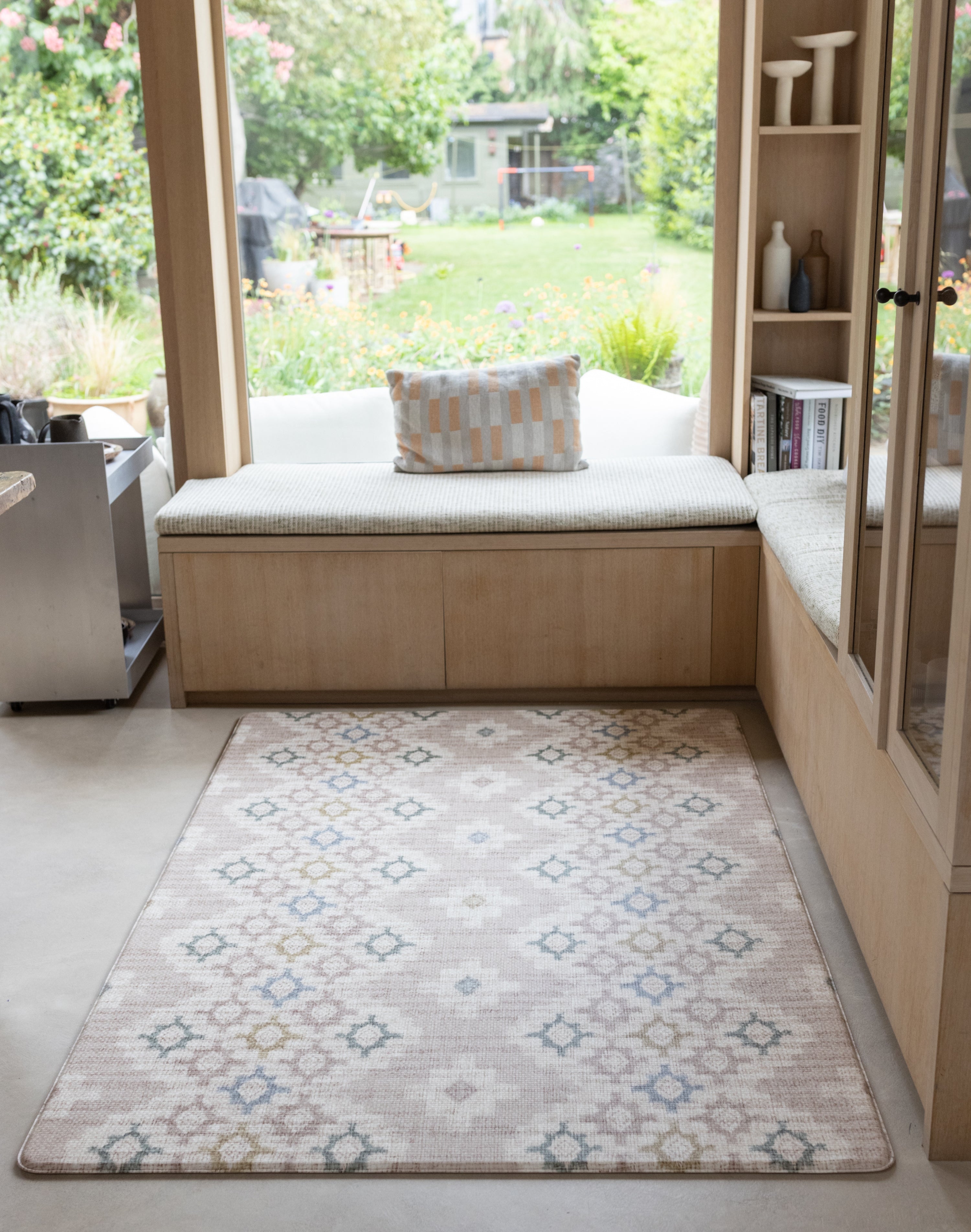 Totter + Tumble playmat in compact size sitting in a corner of a kitchen with snug bench area for the whole family to enjoy
