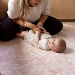 baby and mum lying on soft floor mat pink round shape totter and tumble safe from newborn