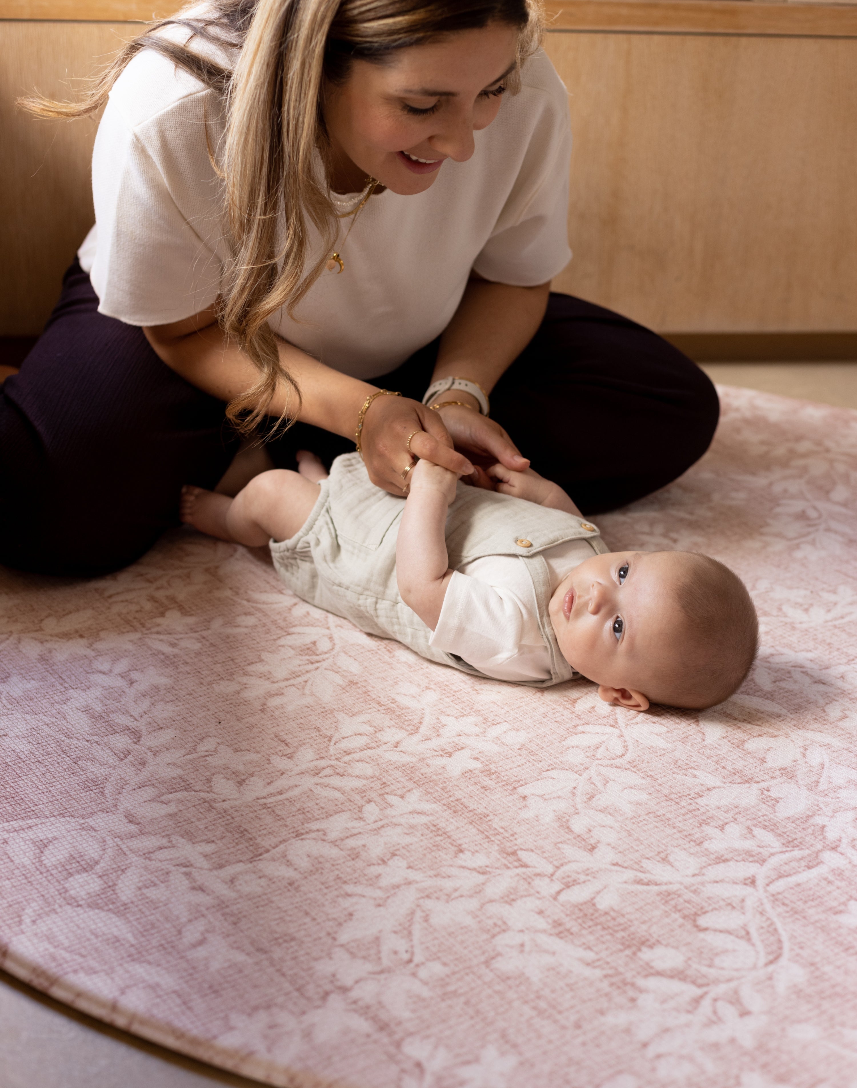 baby and mum lying on soft floor mat pink round shape totter and tumble safe from newborn