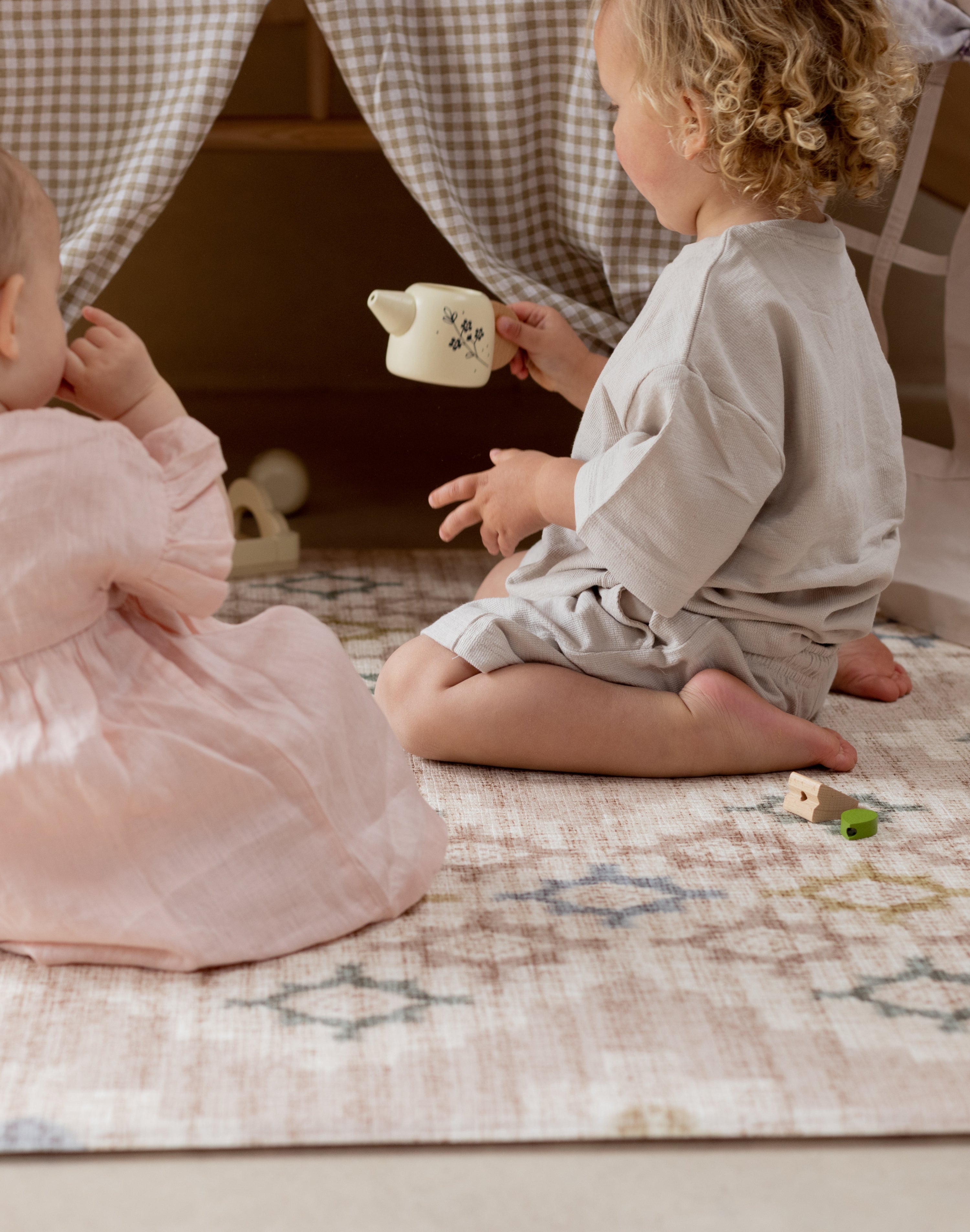 Children playing on a totter and tumble playmat