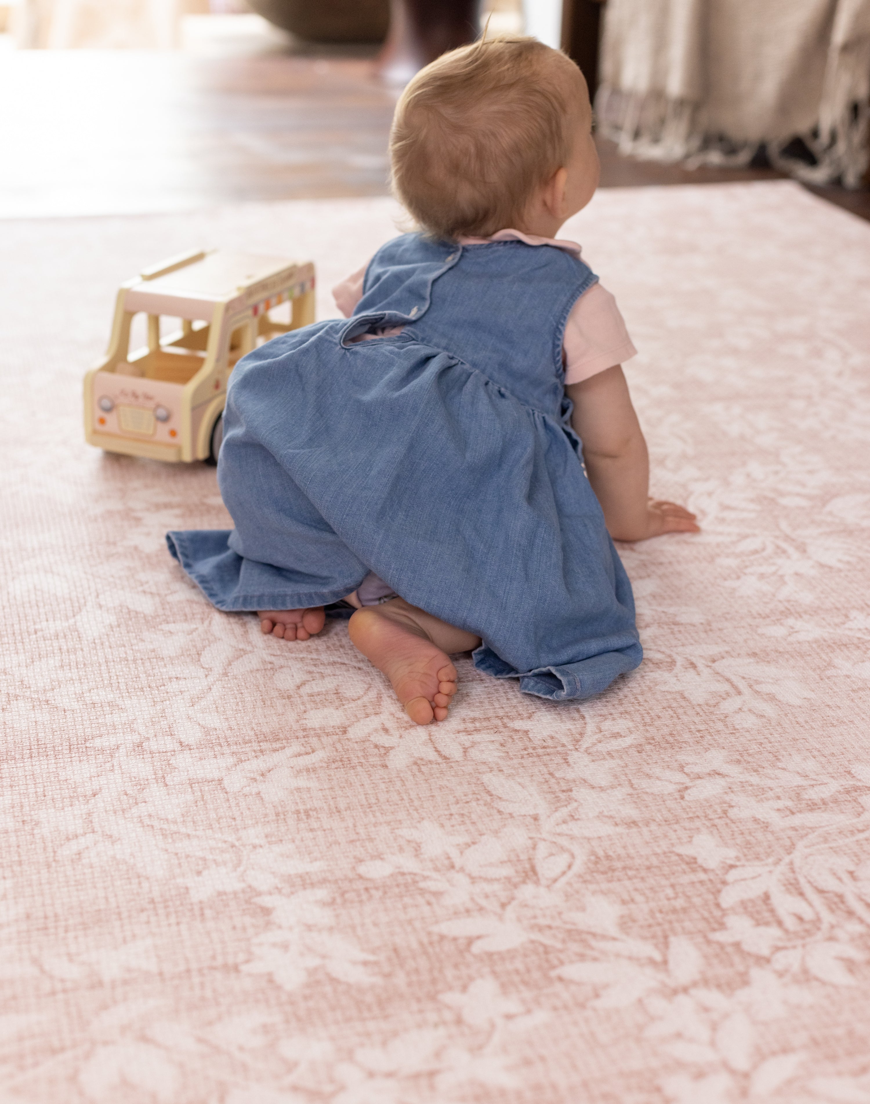 little baby crawling on totter and tumble pink Aster playmat 