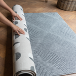 Unrolling a one piece play mat by Totter and Tumble with a reversible design so you can enjoy the organic polka dots of the Eclipse or the aged Kilim motif of the Astronomer