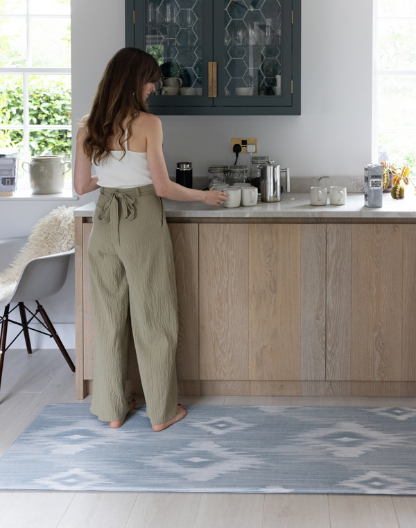 Lady standing on Kitchen runner by Totter and Tumble provides support for joints in the kitchen and can be used as an exercise with stylish design the whole family will love 