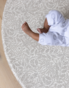totter and tumble comfy playmat for kids and babies lying on playing in grey acorn print from william morris & co collaboration in round shape