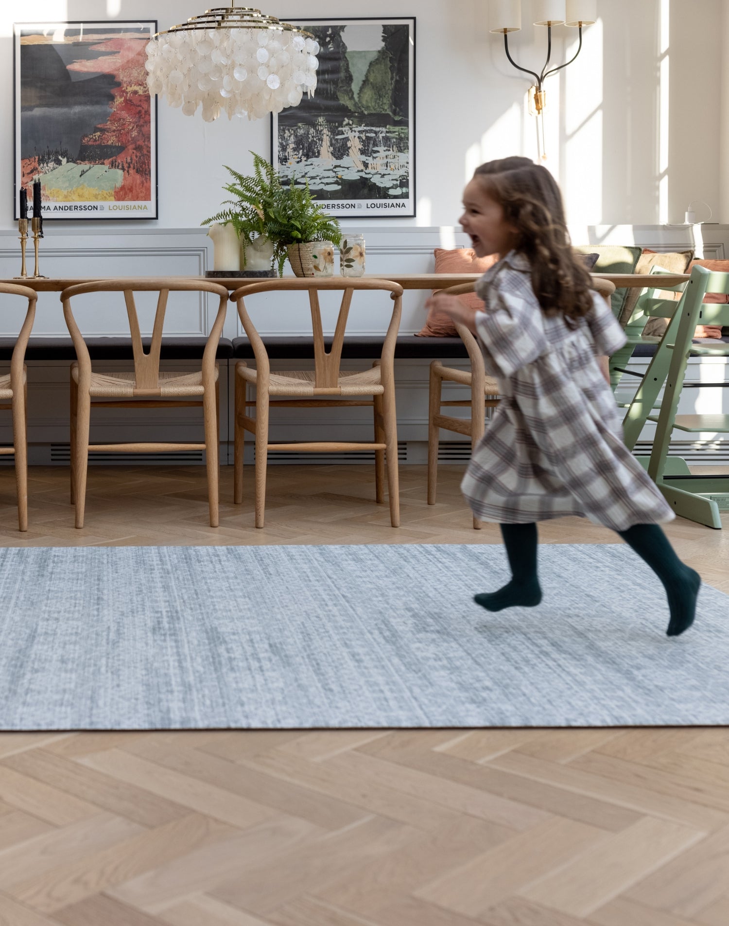 Child happily runs across a large memory foam rug for the living room