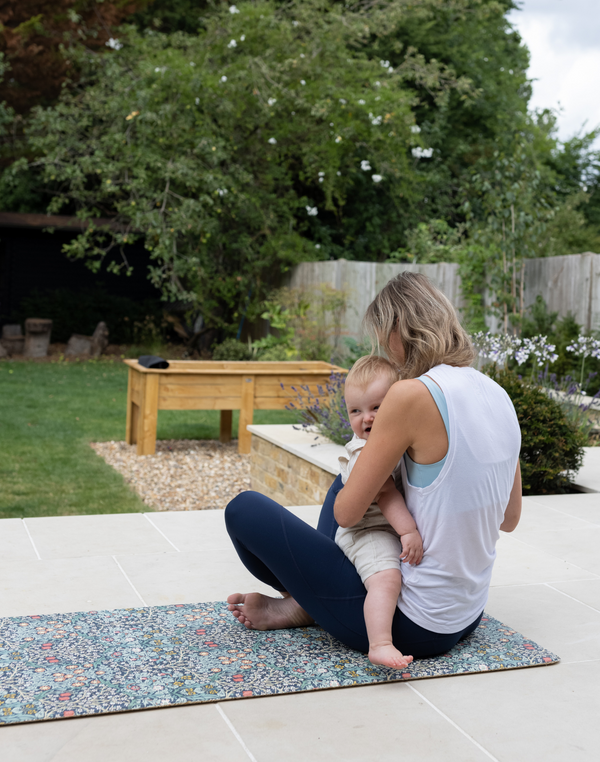 totter and tumble play runner being used outdoors with mum and baby playing together on the floor mat padded foam so you can't feel the floor underneath, non toxic and comfy play mat