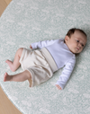 totter and tumble brer rabbit round playmat with baby relaxing on padded foam playmat for toddlers, best baby playmat rug comfy for tummy time and wipeable playmat for any spills or dribbles