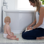 totter + tumble runner size playmat by the bath with mum and baby getting ready for bathtime. Insulates from cold floor, non slip playmat and stylish reversible designs to suit any room in your home