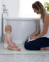 totter + tumble runner size playmat by the bath with mum and baby getting ready for bathtime. Insulates from cold floor, non slip playmat and stylish reversible designs to suit any room in your home