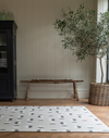 Monochrome play mat with organic polka design that complements contemporary family homes 
