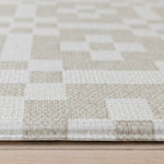 Corner close-up of The Holbein, a Welsh tapestry playmat with textured, tufted surface in natural tones.