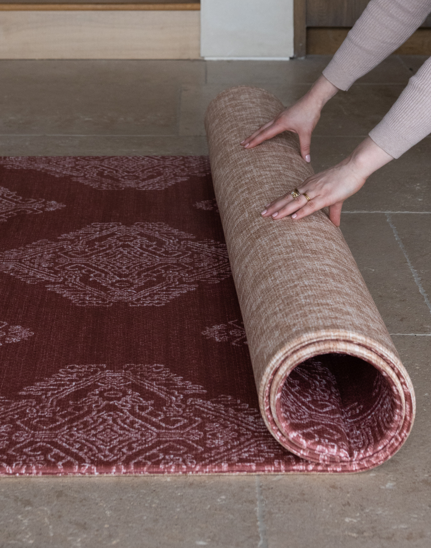 Unrolling one piece memory foam play mat The Merah and The Rusa with the aesthetic of a rug provides protection on tiled and wood flooring