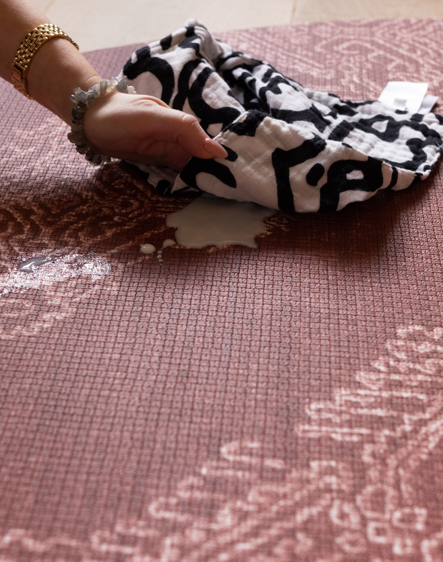 Wiping milk spill up on sealed play mat surface