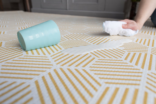 Totter + Tumble luxury padded playmat design-led reversible rug for the whole family. The Keeper playmat with mustard yellow hexagonal design great for stylish families