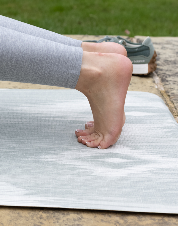 Thick memory foam and a textured surface provides support and traction for lady exercising on totter and tumble runner play mat