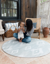 Mother and baby enjoying large round play mat made with thick foam and safe materials