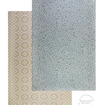 Overhead view of a soft luxurious crawling mat for babies in seagrass blue. On the reverse, a neutral brown geometric design