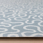 Close-up of The Pembroke, a textured baby playmat with a handwoven style in a sea foam blue, ideal as a tummy time mat.