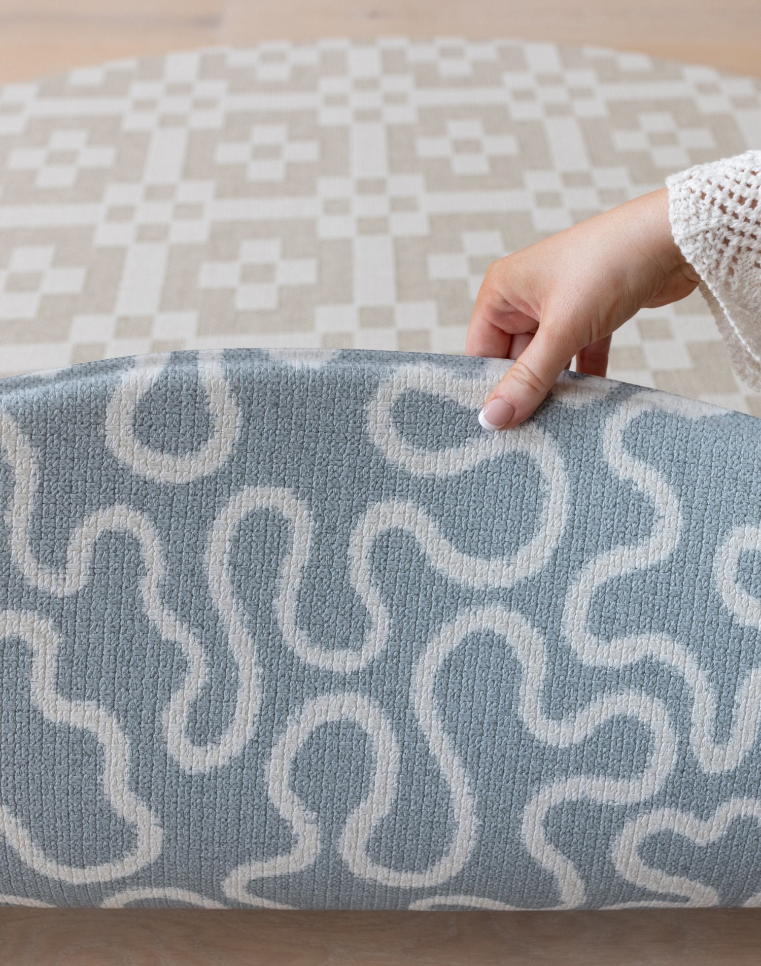 Lifting The Pembroke and Holbein, a designer playmat with textured surface, to reveal the reverse design