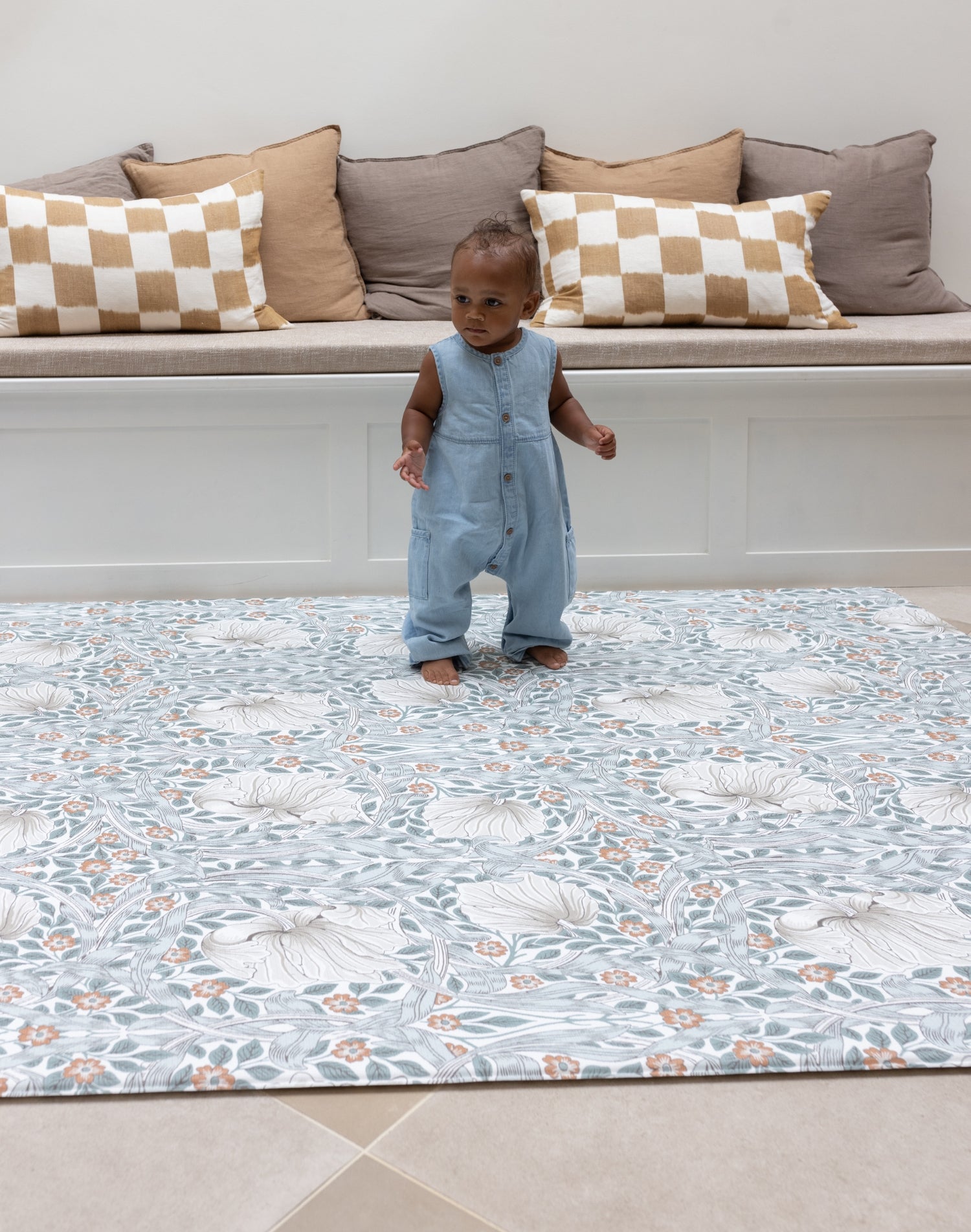 Baby standing on padded totter and tumble playmat from Morris and Co Collaboration