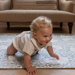 crawling baby on stylish William Morris playmat