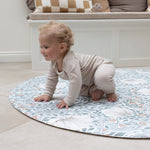 Baby crawling on round pimpernel playmat