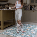 Mum and baby in family kitchen using padded playmat with Morris Pimpernel in green