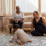 grandparents playing with toddler on comfy and stylish playmat