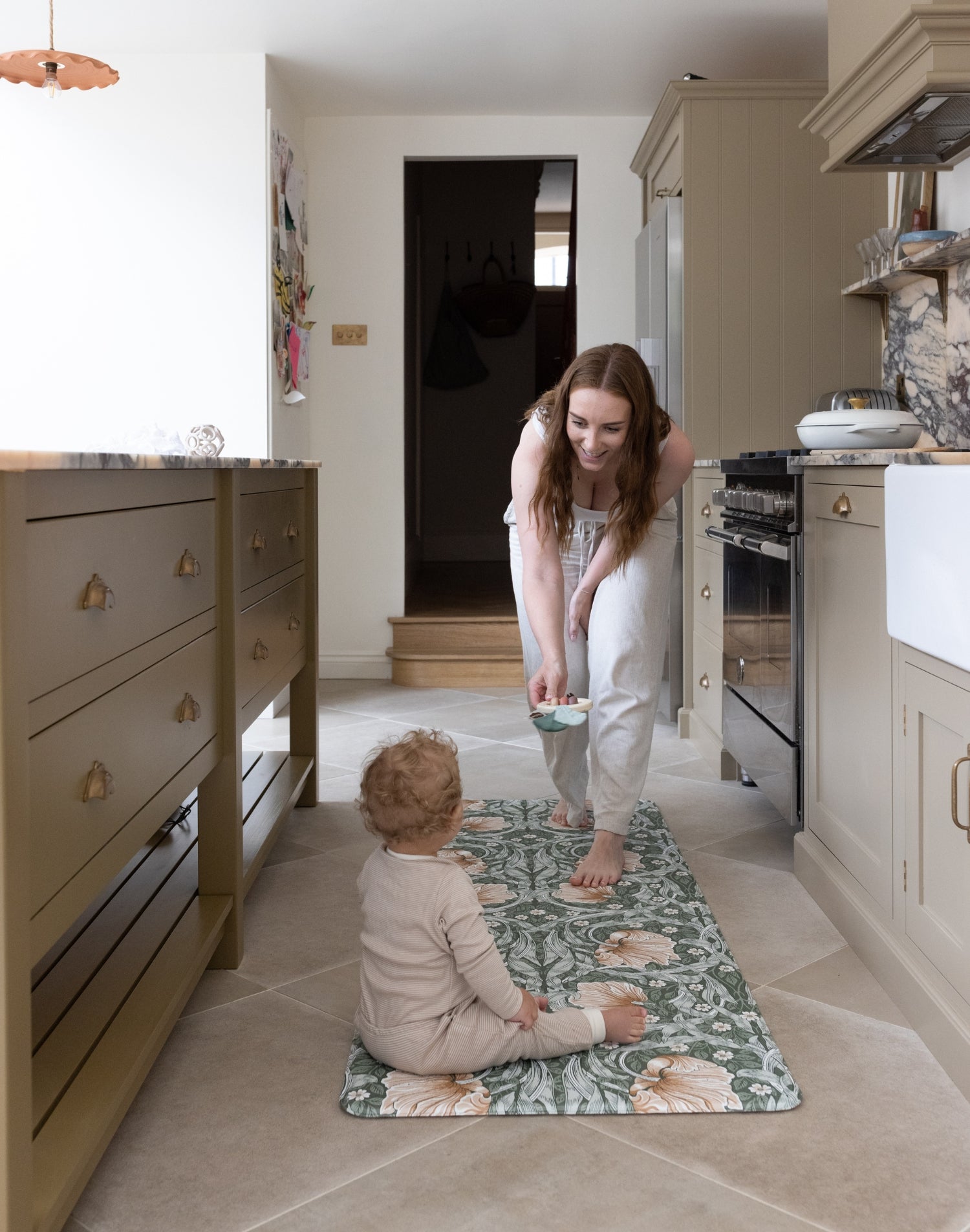 mum and baby on wipeable kitchen runner 