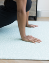 Exercising hands are supported on the thick floor mat by Totter and Tumble that provides protection from hard wood floors