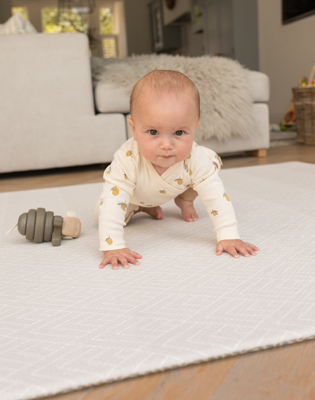 Baby crawling and playing on padded playmat with wooden toy | SKU: 066 MARIN/ROAM,COMPACT MARIN/ROAM