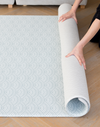 Unrolling neutral play mat ideal for modern interiors with gentle scallop and chevron designs