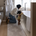 Mother and baby prepare for bath time keeping comfortable on the memory foam bath room mat the sepi with a grey design that sits subtly in modern bathroom designs also use the mat as a kitchen mat runner or exercise mat in the home 