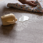 Hand wipes up milk spill on waterproof play mat the sepi that allows for easy cleaning in the family home and does not harbour dirt or dust an allergy friendly play mat option