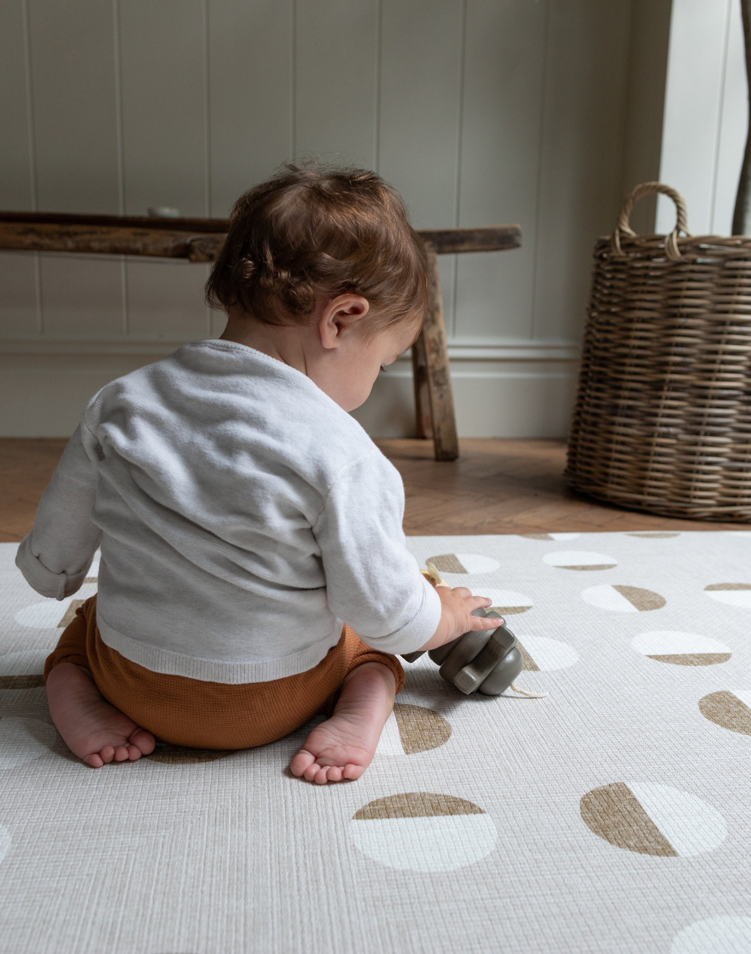 Little boy kneels on knee saving playmat with luxury memory foam for support 