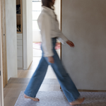 Lady walks across the leopard print hallway runner mat providing warm and protection underfoot on hard wood flooring