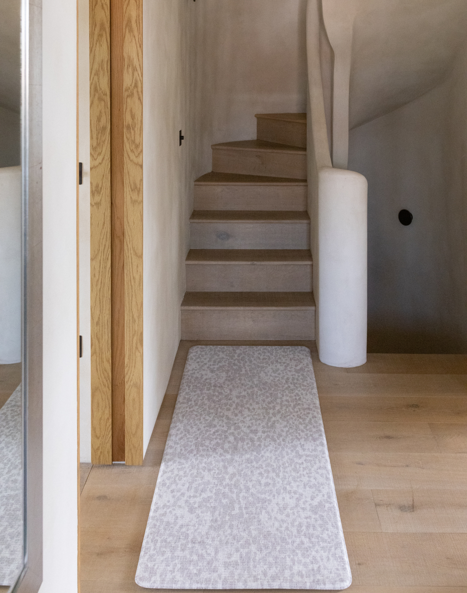 Beautiful grey hallway runner in modern boho home the light grey floor mat is stylish and subtle