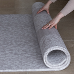 Unrolling grey play mat the sunda with the complementary sepi design on the reverse a subtle duo that sits stylishly in the family home while providing protection on tile and hard wood flooring