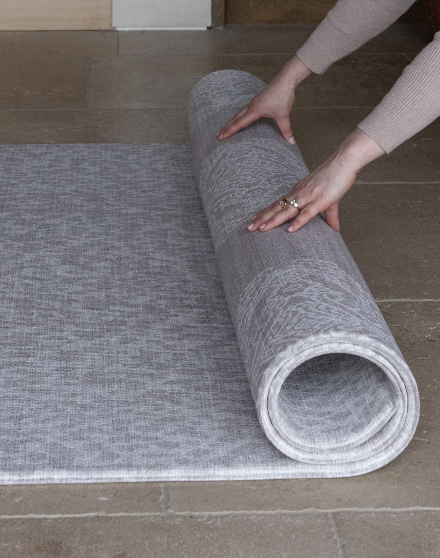 Unrolling grey play mat the sunda with the complementary sepi design on the reverse a subtle duo that sits stylishly in the family home while providing protection on tile and hard wood flooring