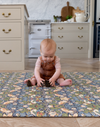 baby playing on totter and tumble padded playmat in morris & co strawberry thief designed for family life one piece, wipedown easy clean play mats alternative to rug