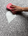 Wiping up milk spillage with sponge on wipeable playmat by totter and tumble 