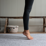 Legs are supported during exercise on the exercise mat by totter and tumble with grey leopard print design 