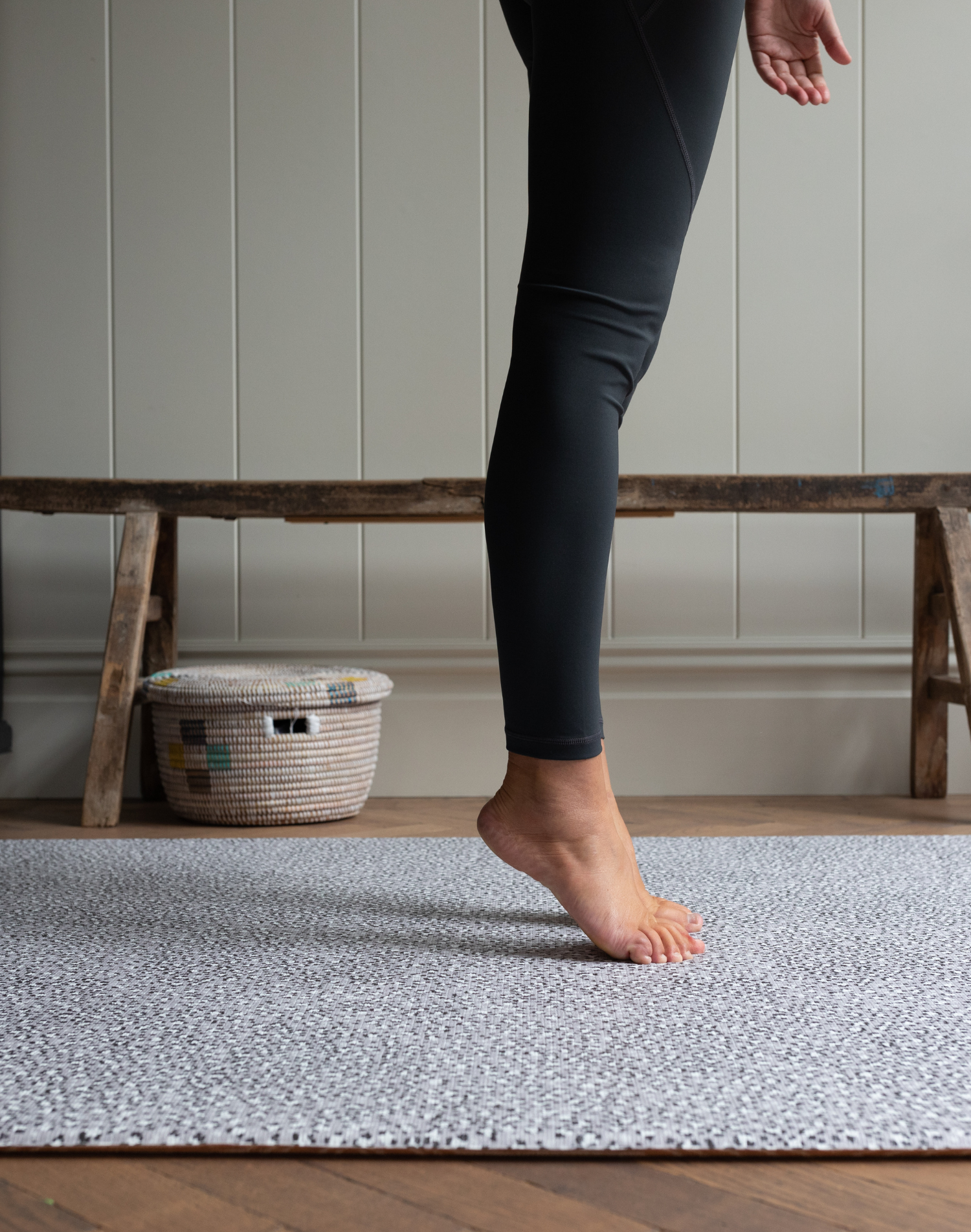 Legs are supported during exercise on the exercise mat by totter and tumble with grey leopard print design 