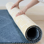 Unrolling thick one piece play rug by Totter and Tumble with Wanderlust design and honeycomb Keeper on the reverse 