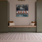 Room interior with the Totter + Tumble Weaver crawling mat for babies. A heritage-inspired play mat in earthy brown red tones
